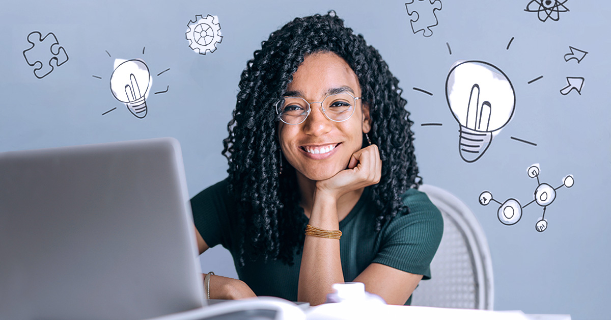 African American girl sitting at table infront of laptop and smiling, with icons depicting brainstorming notes.