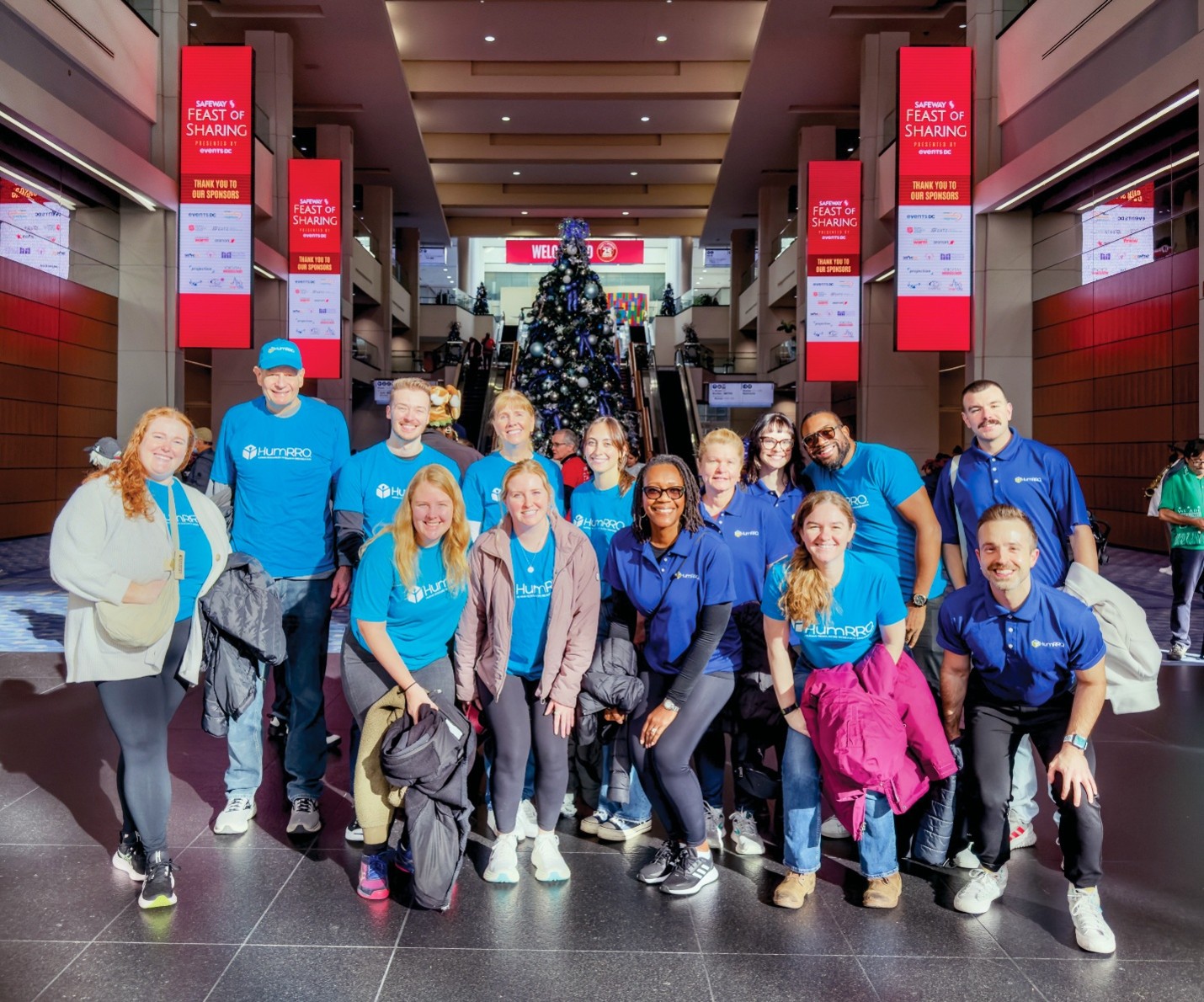 Group of HumRROvians gathered at a conference wearing the HumRRO blue shirts